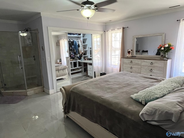 bedroom with crown molding, ceiling fan, and a closet