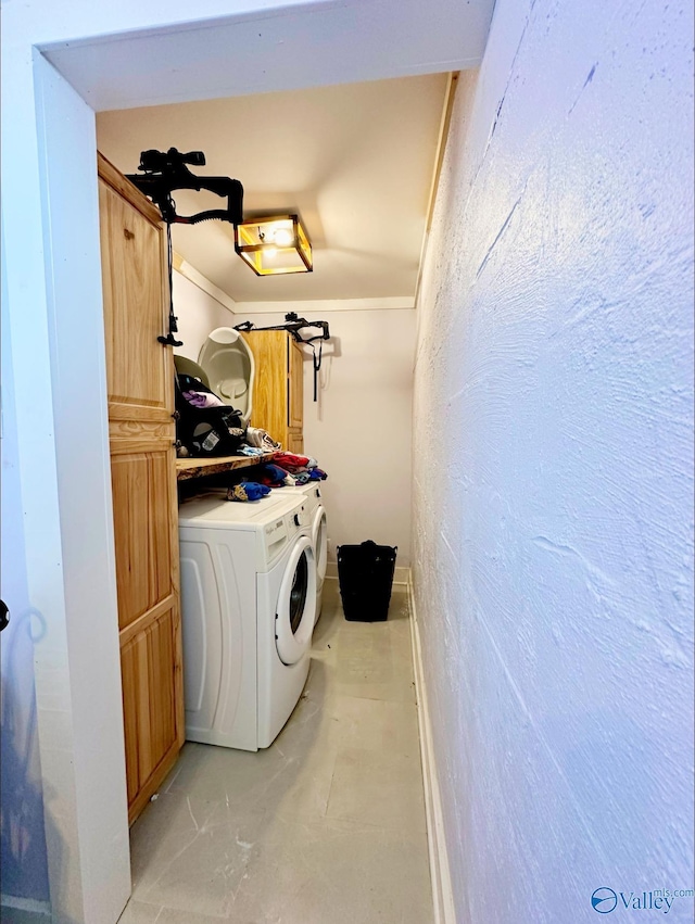 laundry room with cabinets and washer / dryer