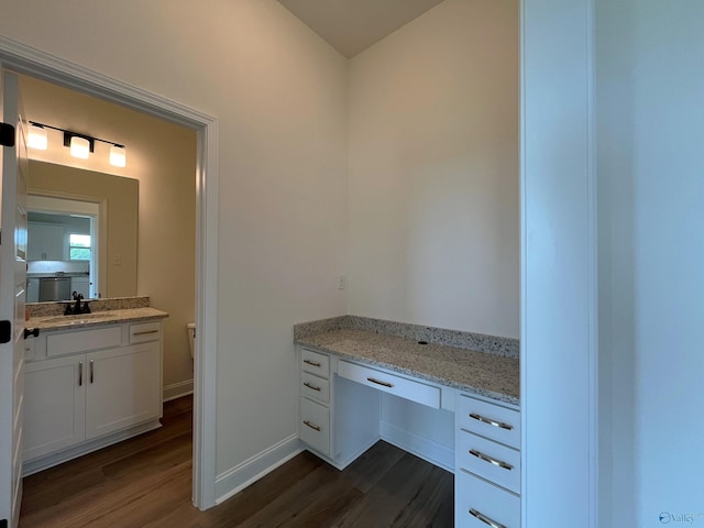 bathroom featuring vanity, toilet, and hardwood / wood-style floors