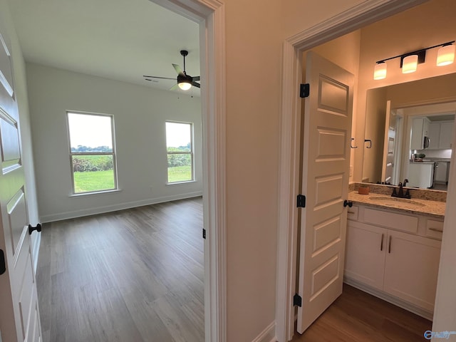 bathroom featuring vanity, wood-type flooring, and ceiling fan