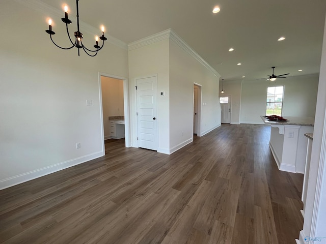 unfurnished living room featuring dark wood-type flooring, ornamental molding, and ceiling fan with notable chandelier