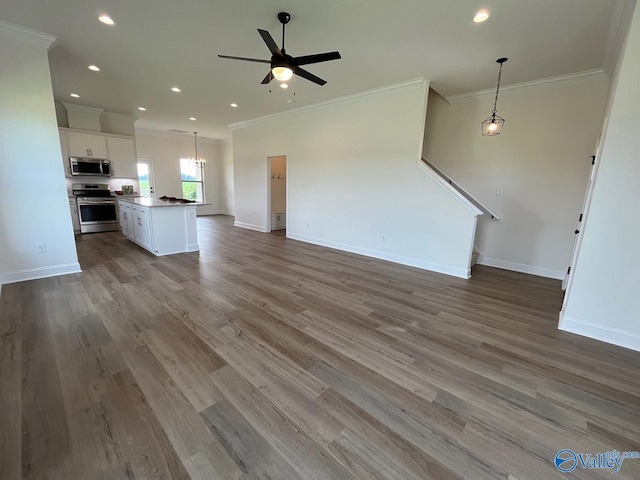 kitchen with decorative light fixtures, white cabinets, a center island, ceiling fan, and stainless steel appliances