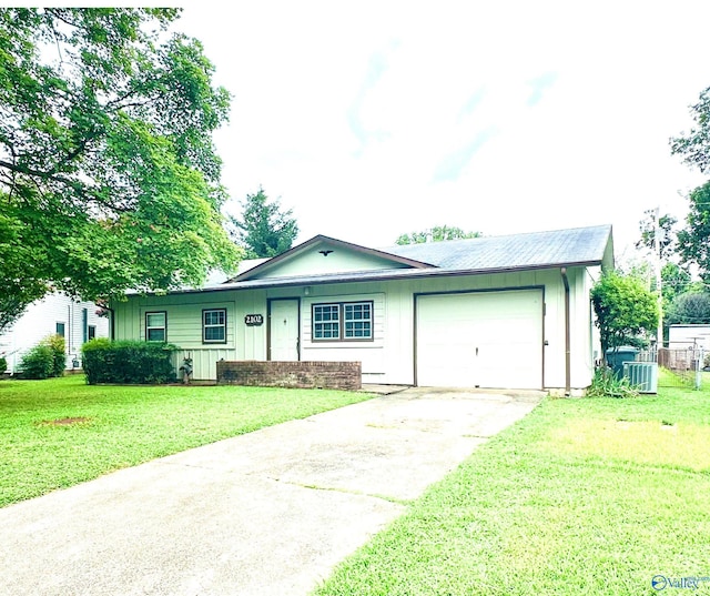 single story home with a garage and a front lawn