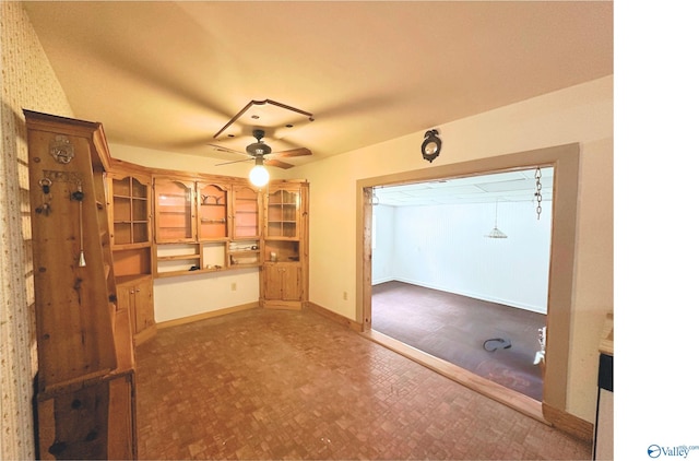 interior space with tile patterned floors and ceiling fan