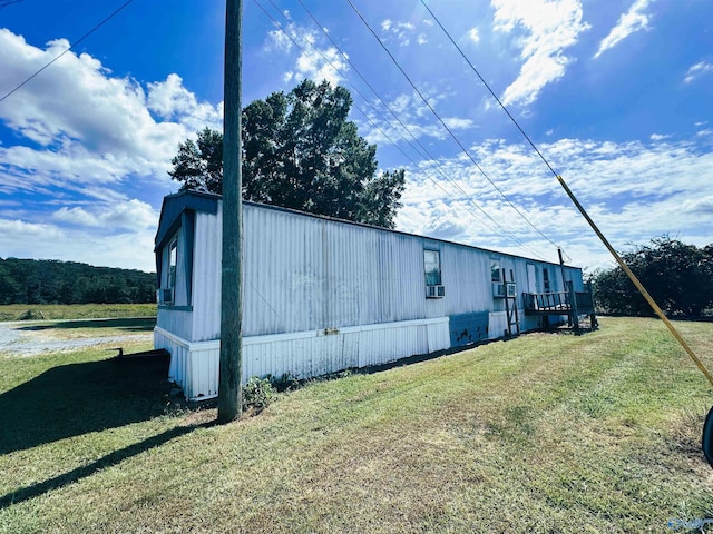 view of home's exterior with a yard and cooling unit