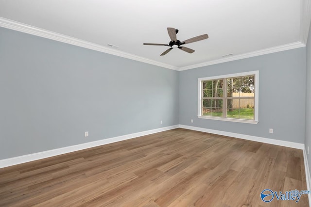 empty room featuring ornamental molding, ceiling fan, and light wood-type flooring