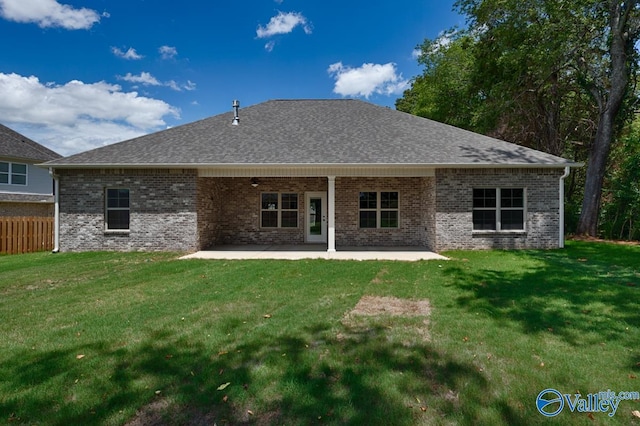 back of property featuring a lawn and a patio area