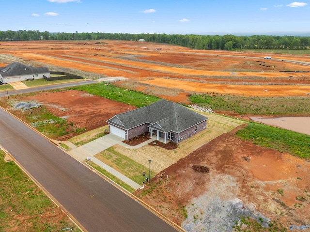 birds eye view of property with a rural view