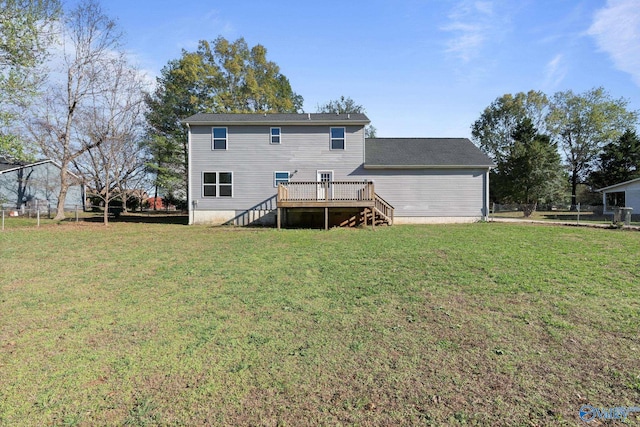 back of house with a yard and a deck