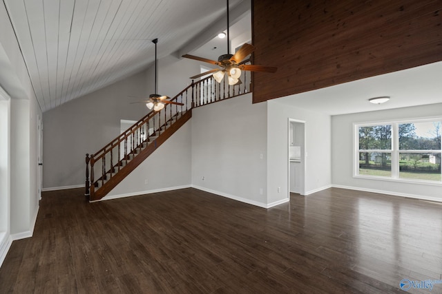 unfurnished living room featuring ceiling fan, dark hardwood / wood-style flooring, beamed ceiling, and wood ceiling