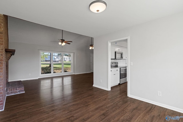 unfurnished living room with dark hardwood / wood-style floors, ceiling fan, a fireplace, and vaulted ceiling