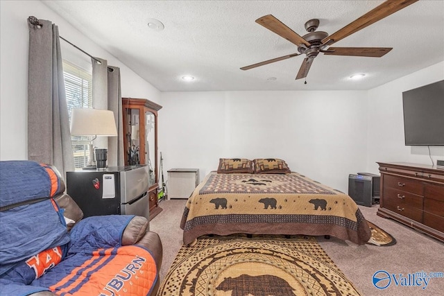 bedroom featuring carpet, a textured ceiling, and ceiling fan