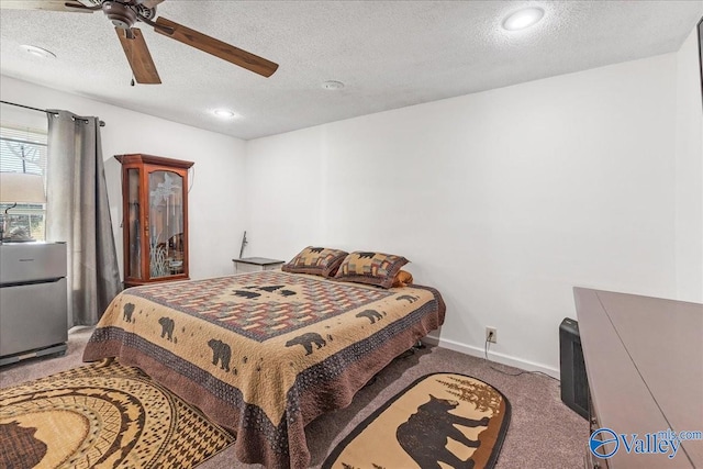 bedroom featuring carpet, a textured ceiling, and ceiling fan