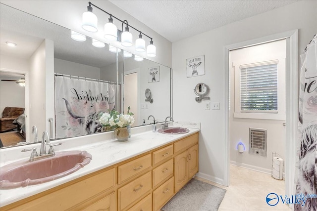 bathroom with vanity, a textured ceiling, heating unit, and ceiling fan