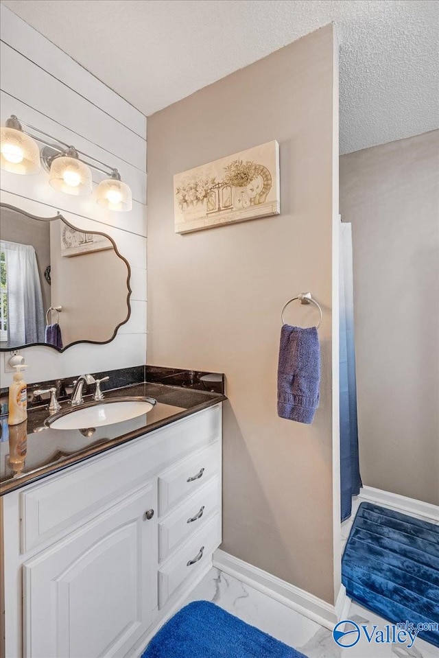 bathroom featuring vanity and a textured ceiling