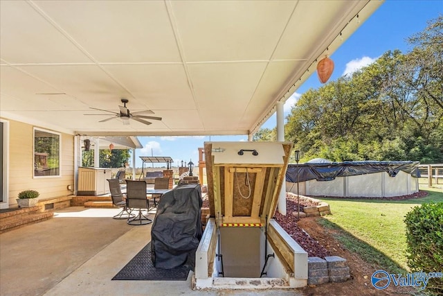 view of patio / terrace featuring a covered pool and ceiling fan