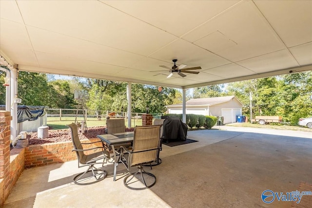 view of patio featuring an outbuilding and ceiling fan