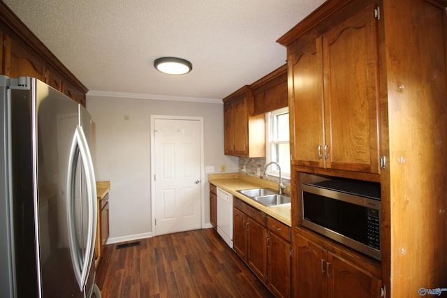 115 Kathleen Dr, Hazel Green, AL 35750 - kitchen with appliances with stainless steel finishes, a sink, dark wood-type flooring, light countertops, and crown molding