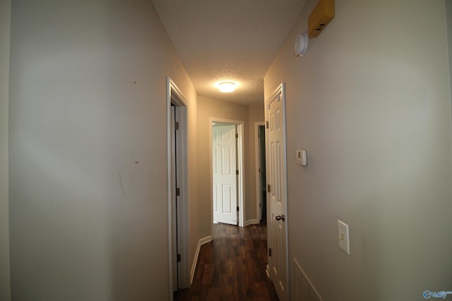 115 Kathleen Dr, Hazel Green, AL 35750 - corridor featuring a textured ceiling, dark wood finished floors, and baseboards