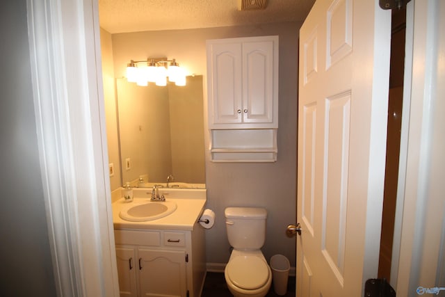 115 Kathleen Dr, Hazel Green, AL 35750 - bathroom with toilet, vanity, and a textured ceiling