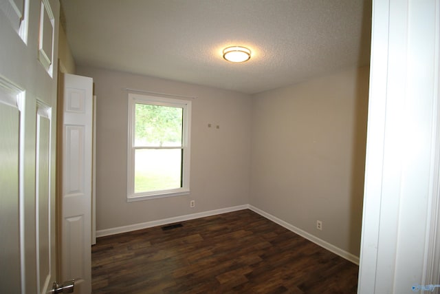 115 Kathleen Dr, Hazel Green, AL 35750 - unfurnished room featuring dark wood-type flooring, a textured ceiling, and baseboards