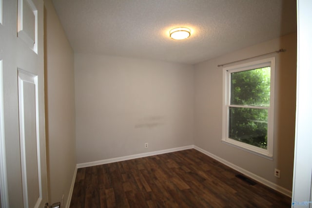 115 Kathleen Dr, Hazel Green, AL 35750 - spare room with dark wood-type flooring, a textured ceiling, and baseboards
