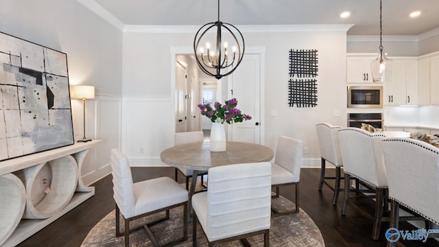 dining area with crown molding, a chandelier, and dark hardwood / wood-style floors