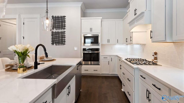 kitchen featuring pendant lighting, dark hardwood / wood-style flooring, stainless steel appliances, and white cabinets