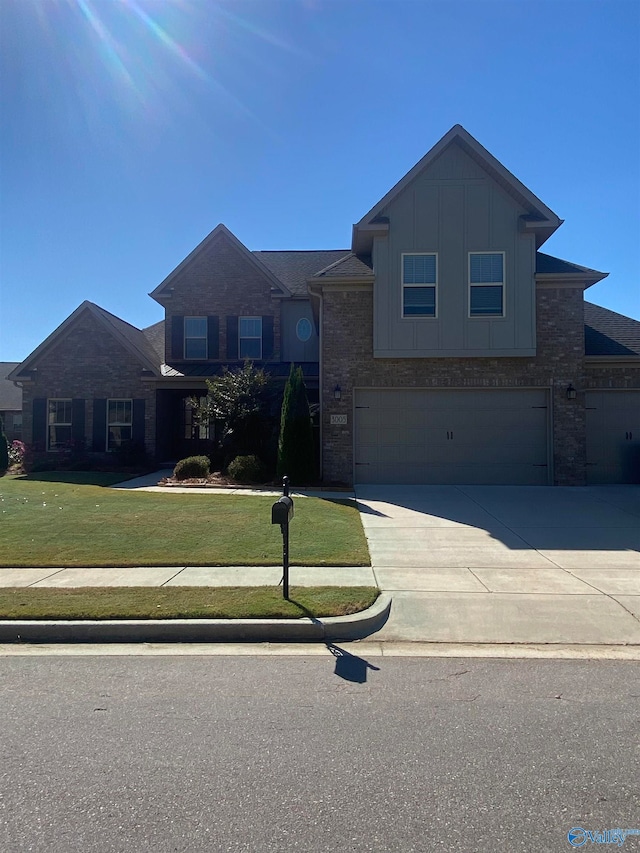 view of front of house featuring a front lawn and a garage