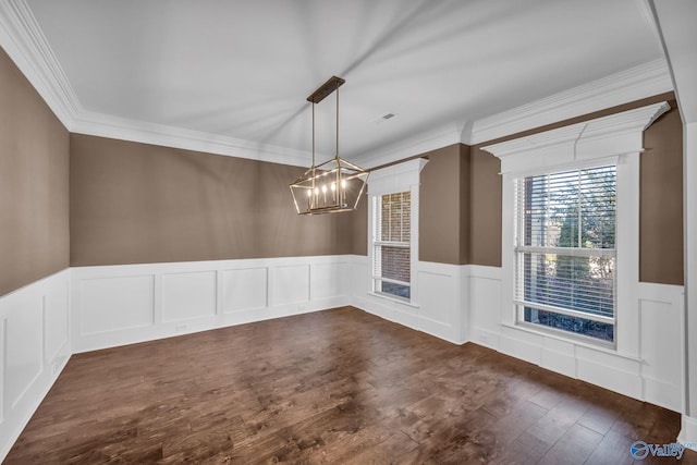 unfurnished dining area with ornamental molding, a chandelier, and dark hardwood / wood-style floors