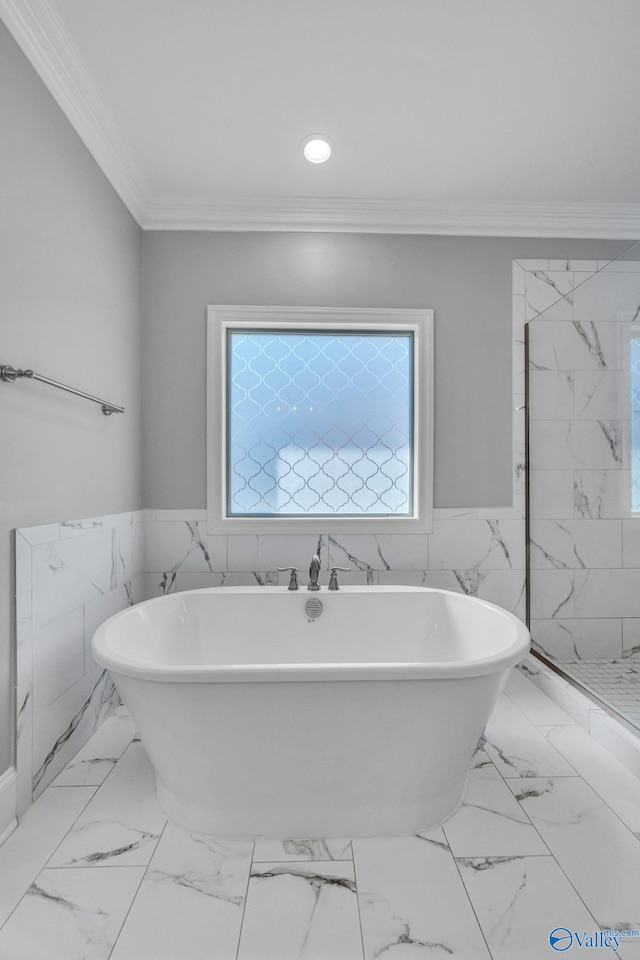 bathroom with crown molding, tile walls, and separate shower and tub