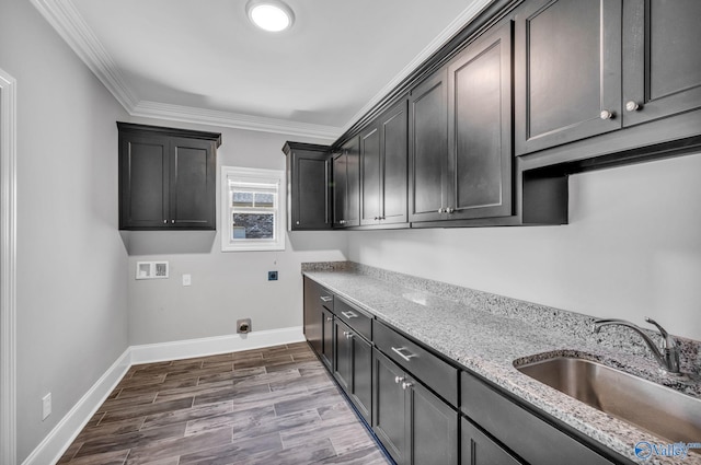 laundry room with hookup for a washing machine, wood-type flooring, sink, ornamental molding, and cabinets