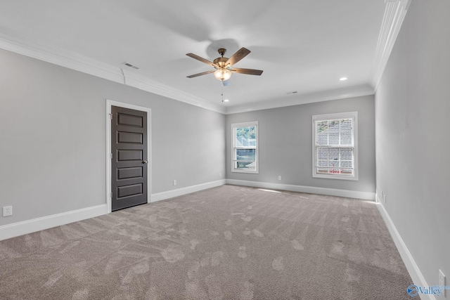 empty room with ceiling fan, ornamental molding, and carpet floors