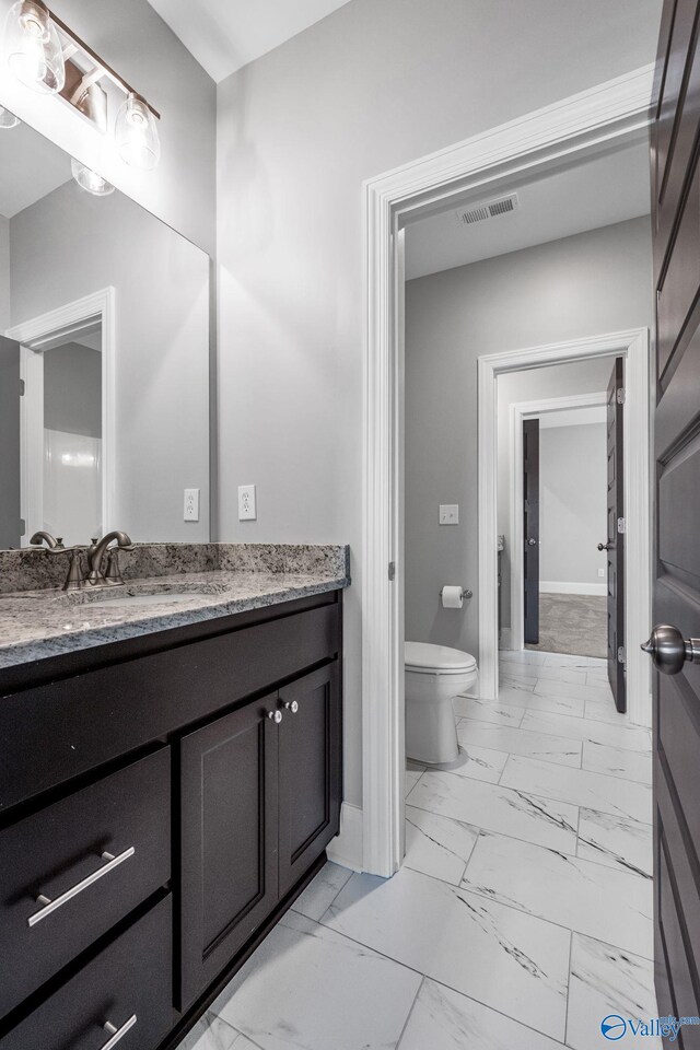 bathroom with vanity and toilet