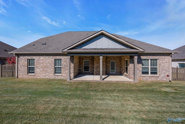 rear view of house with a yard and a patio