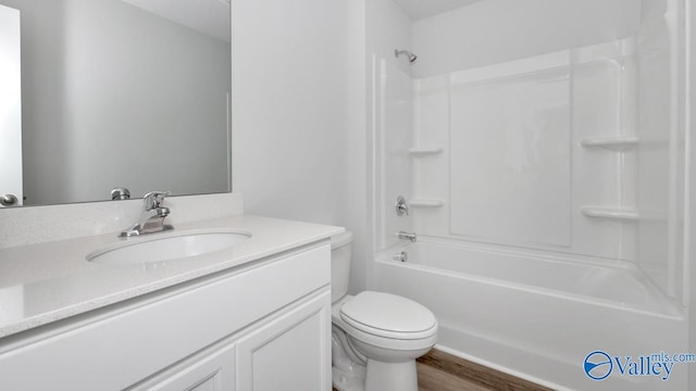 full bathroom featuring tub / shower combination, wood finished floors, toilet, and vanity