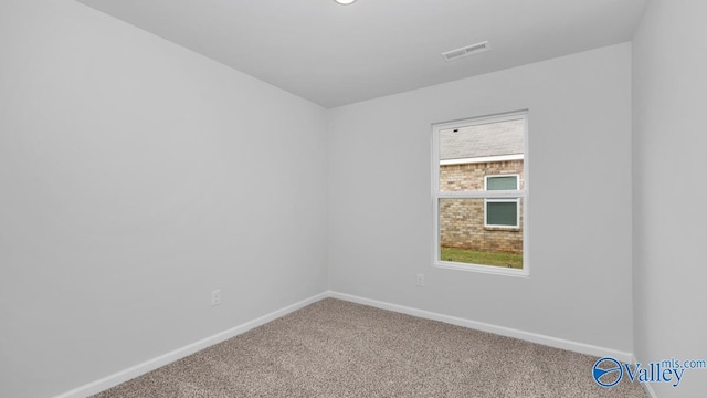 empty room with visible vents, baseboards, and carpet floors