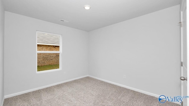 carpeted spare room with recessed lighting, visible vents, and baseboards