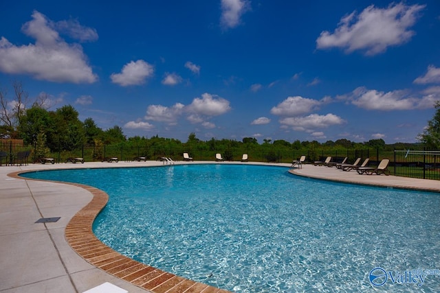 pool featuring a patio and fence