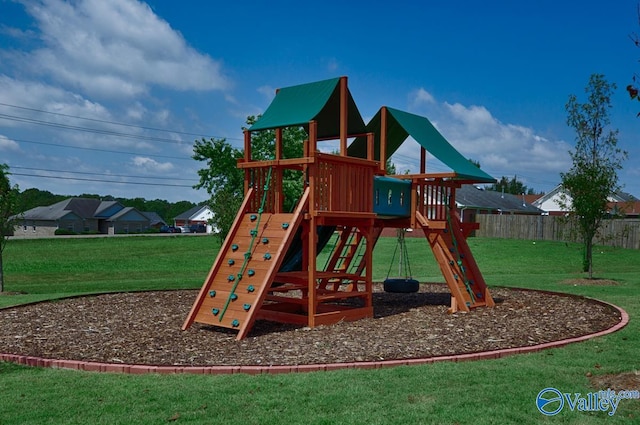 view of jungle gym featuring a yard and fence