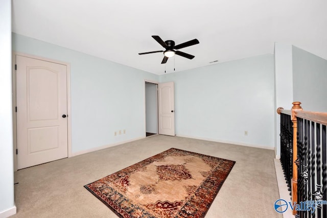 empty room featuring baseboards, visible vents, a ceiling fan, and light colored carpet