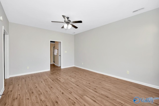 interior space featuring baseboards, ceiling fan, visible vents, and light wood-style floors