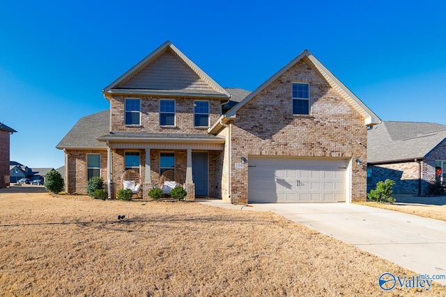 view of front of home with a garage, a front yard, and a porch