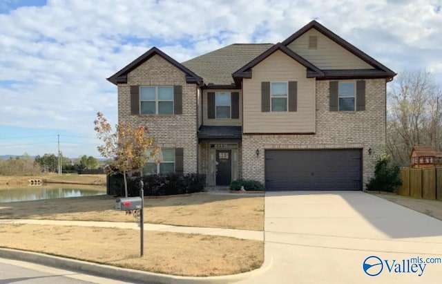 craftsman-style house with a garage and a water view