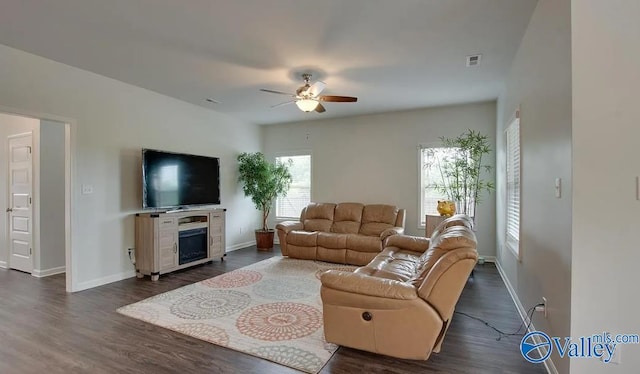 living room with dark hardwood / wood-style flooring and ceiling fan