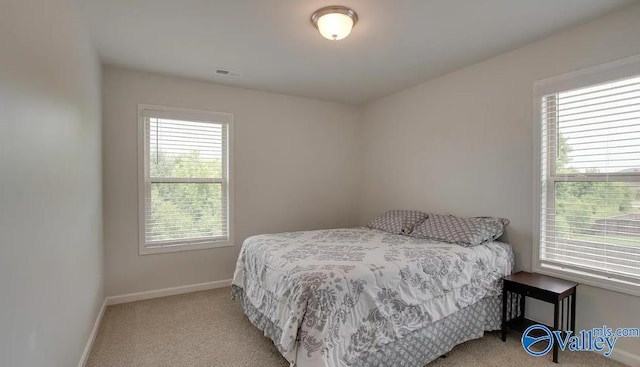 bedroom featuring light colored carpet