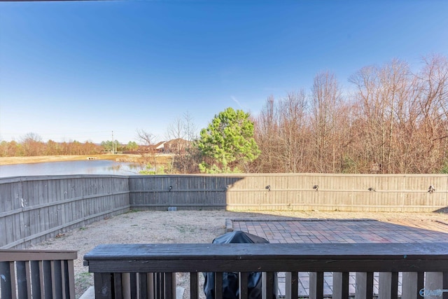 wooden terrace featuring a water view