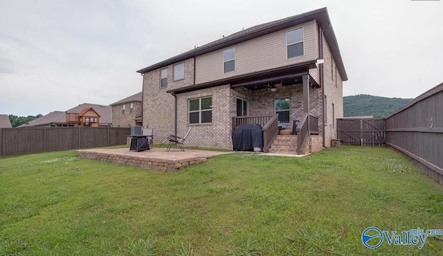 back of property featuring a yard and a patio area