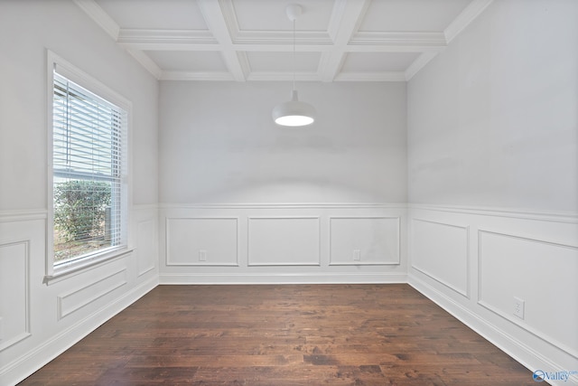 spare room featuring a wealth of natural light, beamed ceiling, coffered ceiling, and dark hardwood / wood-style flooring