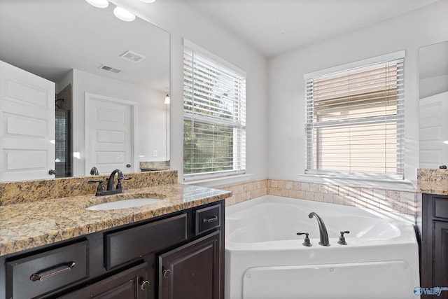 bathroom with a bath and vanity